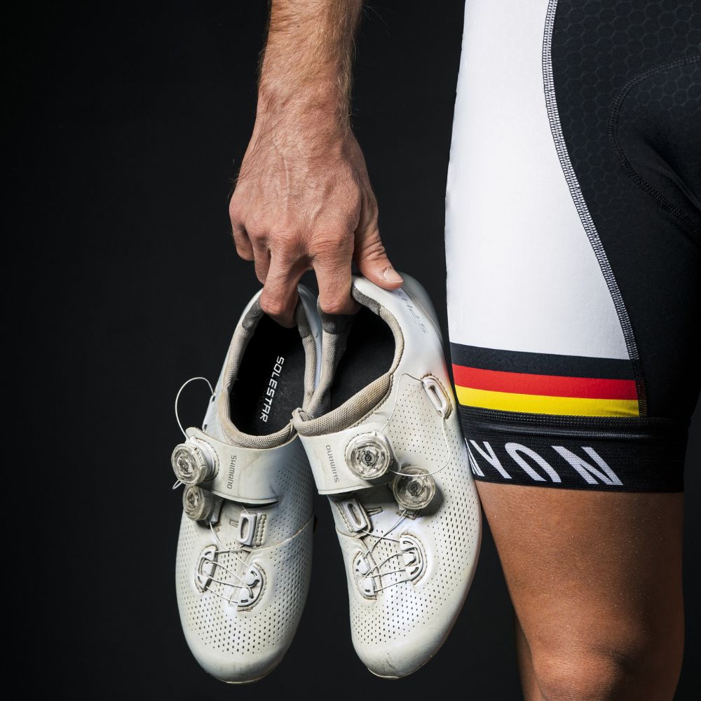 Professional cyclist wearing cycling shoes and Solestar carbon fiber insoles.