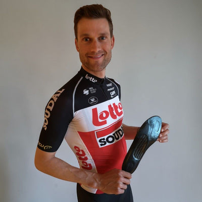  Nicolas Maes wearing a cycling jersey with Lotto Soudal branding, holding a cycling shoe insert.